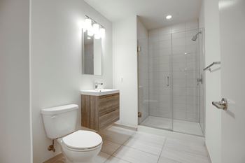 A white toilet sits next to a sink in a bathroom.